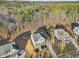 Aerial view of a two-story house in a wooded neighborhood at 678 The Parks Dr, Pittsboro, NC 27312