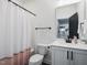 Clean bathroom with white vanity, shower/tub combo, and a mirror at 678 The Parks Dr, Pittsboro, NC 27312