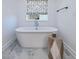Relaxing bathroom featuring a freestanding bathtub and stylish flooring at 678 The Parks Dr, Pittsboro, NC 27312