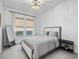 Light and airy bedroom with a queen bed, full-length mirror, and window seating at 678 The Parks Dr, Pittsboro, NC 27312