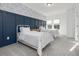 Charming bedroom with twin beds, navy blue accent wall, and patterned wallpaper at 678 The Parks Dr, Pittsboro, NC 27312