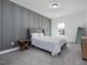Bright bedroom with gray accent wall, carpet, and a queen-size bed at 678 The Parks Dr, Pittsboro, NC 27312