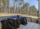 Wooden deck with two covered grills and a view of the backyard at 678 The Parks Dr, Pittsboro, NC 27312