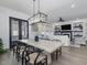 Bright dining room features a large wooden table with black chairs, and an open floor plan at 678 The Parks Dr, Pittsboro, NC 27312