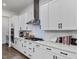 White kitchen cabinets, quartz countertops, and stainless steel appliances at 678 The Parks Dr, Pittsboro, NC 27312