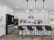 Modern kitchen with white cabinets, quartz countertops, and an island at 678 The Parks Dr, Pittsboro, NC 27312