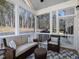 Relaxing screened porch with wicker furniture and wooded views at 678 The Parks Dr, Pittsboro, NC 27312
