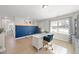 Home office with blue accent wall, desk, and built-in shelving at 70 Kinsale Ct, Fuquay Varina, NC 27526