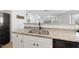 Kitchen features double sink, granite counters, and white cabinets at 70 Kinsale Ct, Fuquay Varina, NC 27526
