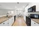 Open concept kitchen with island, white cabinets, and stainless steel appliances at 70 Kinsale Ct, Fuquay Varina, NC 27526