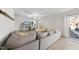Spacious living room with sectional sofa, sliding glass doors, and backyard access at 70 Kinsale Ct, Fuquay Varina, NC 27526