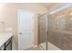 Clean bathroom with glass-enclosed shower, modern vanity, and neutral tile work at 7205 Ladbrooke St, Raleigh, NC 27617