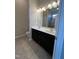 Modern bathroom with double sink vanity, large mirror, and tiled floor at 7205 Ladbrooke St, Raleigh, NC 27617