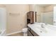 Functional bathroom with a combination tub and shower, storage cabinet, and stylish vanity area at 7205 Ladbrooke St, Raleigh, NC 27617