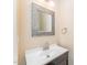 Elegant bathroom featuring a modern vanity with a decorative mirror and sleek faucet at 7205 Ladbrooke St, Raleigh, NC 27617