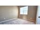 Cozy bedroom featuring a window with blinds, neutral walls, and carpeted flooring for a comfortable feel at 7205 Ladbrooke St, Raleigh, NC 27617