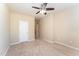 Inviting bedroom with neutral walls, carpet flooring, and a ceiling fan, offering a cozy ambiance at 7205 Ladbrooke St, Raleigh, NC 27617