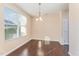 Bright dining room with hardwood floors, a modern chandelier, and ample natural light at 7205 Ladbrooke St, Raleigh, NC 27617