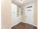 Bright entryway with hardwood floors, built-in storage cabinets, and a windowed front door at 7205 Ladbrooke St, Raleigh, NC 27617