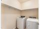 Functional laundry room equipped with a modern washer and dryer set, and ample shelving at 7205 Ladbrooke St, Raleigh, NC 27617