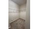 Empty walk-in closet, with neutral walls and carpet, equipped with ample shelving for organization at 7205 Ladbrooke St, Raleigh, NC 27617