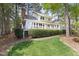 Well-maintained home exterior with a spacious deck overlooking a neatly manicured lawn and mature trees at 76527 Rice, Chapel Hill, NC 27517