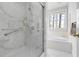 Shower with marble and glass doors next to a bathtub by the window at 76527 Rice, Chapel Hill, NC 27517