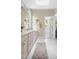 Bright bathroom with double sinks, white tile floor, and access to tub and walk-in closet at 76527 Rice, Chapel Hill, NC 27517
