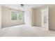 Light-filled bedroom with neutral carpet, large window, and ensuite access at 76527 Rice, Chapel Hill, NC 27517