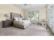 Relax in this bedroom filled with natural light, plush carpet, and a luxurious upholstered bed at 76527 Rice, Chapel Hill, NC 27517