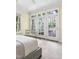 Bright bedroom with large windows offering a view of the lush backyard and a private balcony at 76527 Rice, Chapel Hill, NC 27517