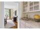 View of dining room through hallway, with marble countertop and glassware on display at 76527 Rice, Chapel Hill, NC 27517