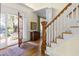 Bright entryway with hardwood floors, staircase, and view into backyard at 76527 Rice, Chapel Hill, NC 27517