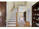 Two-story entryway showcasing a hardwood staircase and access to other rooms at 76527 Rice, Chapel Hill, NC 27517