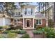 Inviting brick and siding home boasts a beautiful yard, large windows and a welcoming dark wood door at 76527 Rice, Chapel Hill, NC 27517