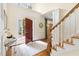 Inviting foyer featuring hardwood floors, staircase, and an open red front door allowing natural light at 76527 Rice, Chapel Hill, NC 27517