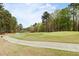 Scenic view of a well-manicured golf course winding through lush greenery and mature trees at 76527 Rice, Chapel Hill, NC 27517