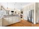 Spacious kitchen with white cabinets, stone countertops, and stainless steel refrigerator at 76527 Rice, Chapel Hill, NC 27517