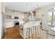 Bright eat-in kitchen with white cabinets, subway tile backsplash and seating at countertop bar at 76527 Rice, Chapel Hill, NC 27517