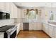 Bright kitchen with custom cabinets, stainless steel appliances, granite countertops and hardwood floors at 76527 Rice, Chapel Hill, NC 27517