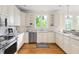 This kitchen showcases ample counter space, white cabinets, and hardwood floors at 76527 Rice, Chapel Hill, NC 27517