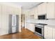 Well-equipped kitchen with stainless steel appliances, custom cabinets, and granite countertops at 76527 Rice, Chapel Hill, NC 27517