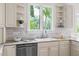 Kitchen features a window overlooking a green space, bright white cabinets, and stainless appliances at 76527 Rice, Chapel Hill, NC 27517