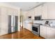 Bright kitchen boasts stainless steel appliances, sleek granite countertops, and white cabinets at 76527 Rice, Chapel Hill, NC 27517
