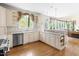 Open kitchen with custom cabinets, stainless steel appliances, and hardwood flooring at 76527 Rice, Chapel Hill, NC 27517
