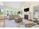 Comfortable living room featuring a vaulted ceiling, fireplace, and large windows providing ample light at 76527 Rice, Chapel Hill, NC 27517