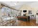 Sun-filled living room featuring hardwood floors, fireplace, and multiple windows with scenic views at 76527 Rice, Chapel Hill, NC 27517