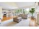 Bright and airy living room with a view of the kitchen, with hardwood floors and large windows at 76527 Rice, Chapel Hill, NC 27517
