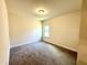 Well-lit bedroom with carpet and window at 78 Falls Of The Cape Dr, Lillington, NC 27546