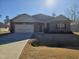 Brick house with 2-car garage, and a well-maintained lawn at 78 Falls Of The Cape Dr, Lillington, NC 27546